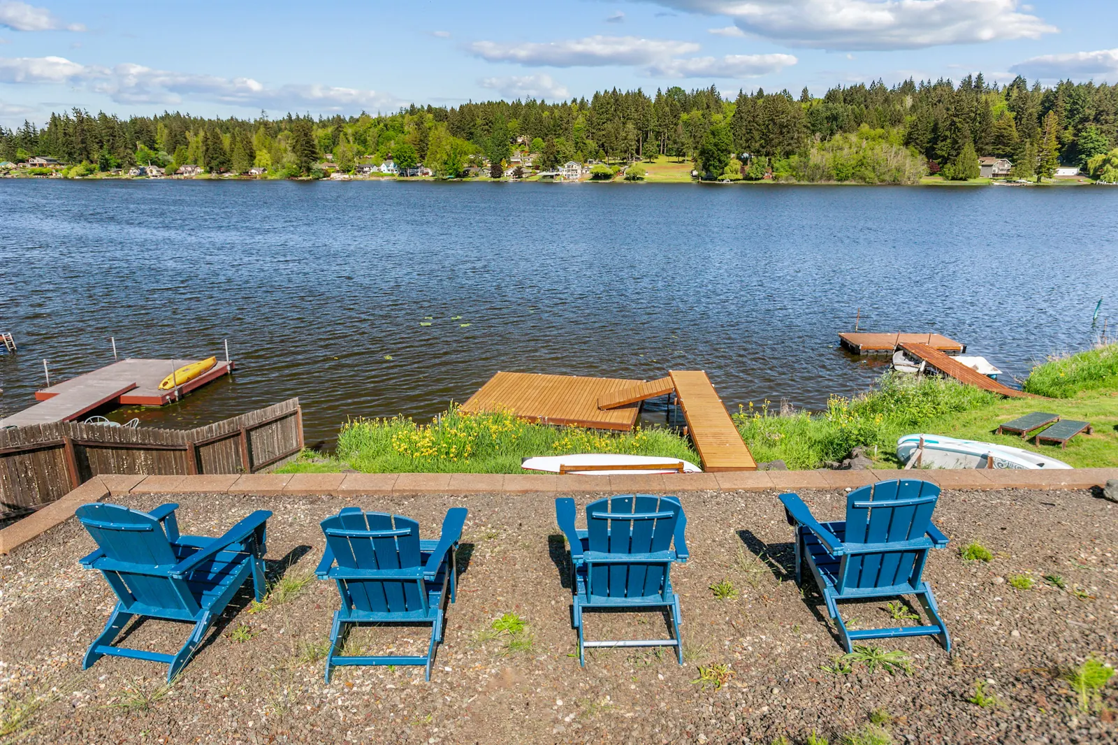 Adirondack chairs overlooking the dock and Long Lake
