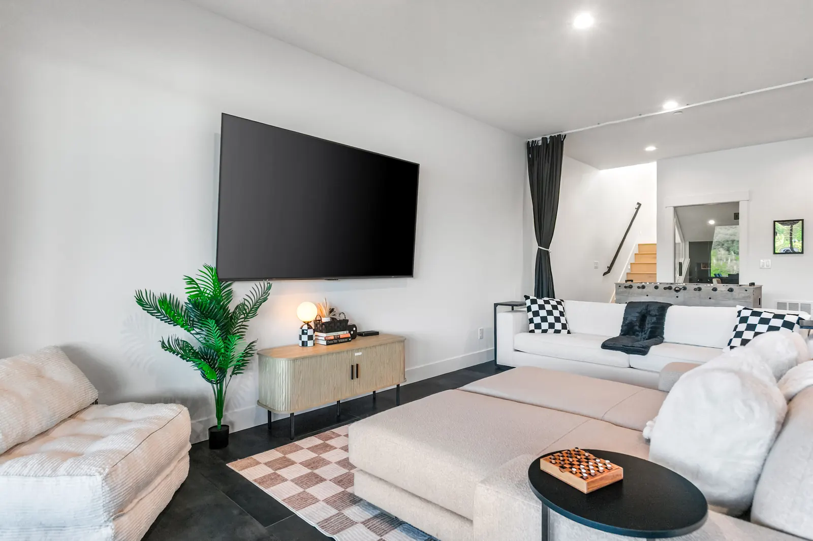 Game lounge with big-screen TV and long sectional seating