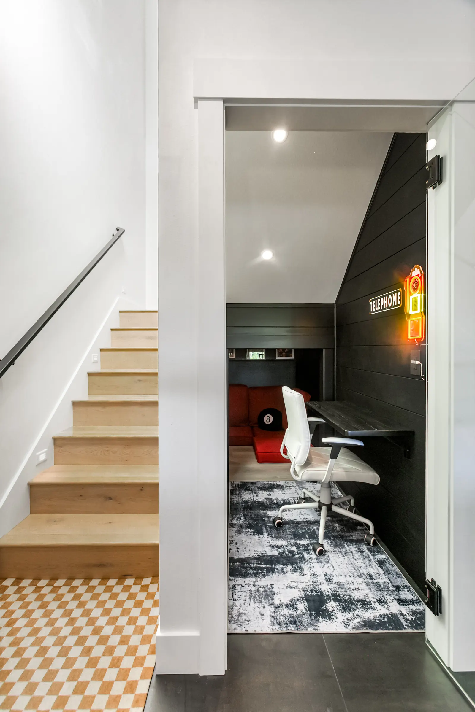 Pull-down desk and office chair in the phone booth nook