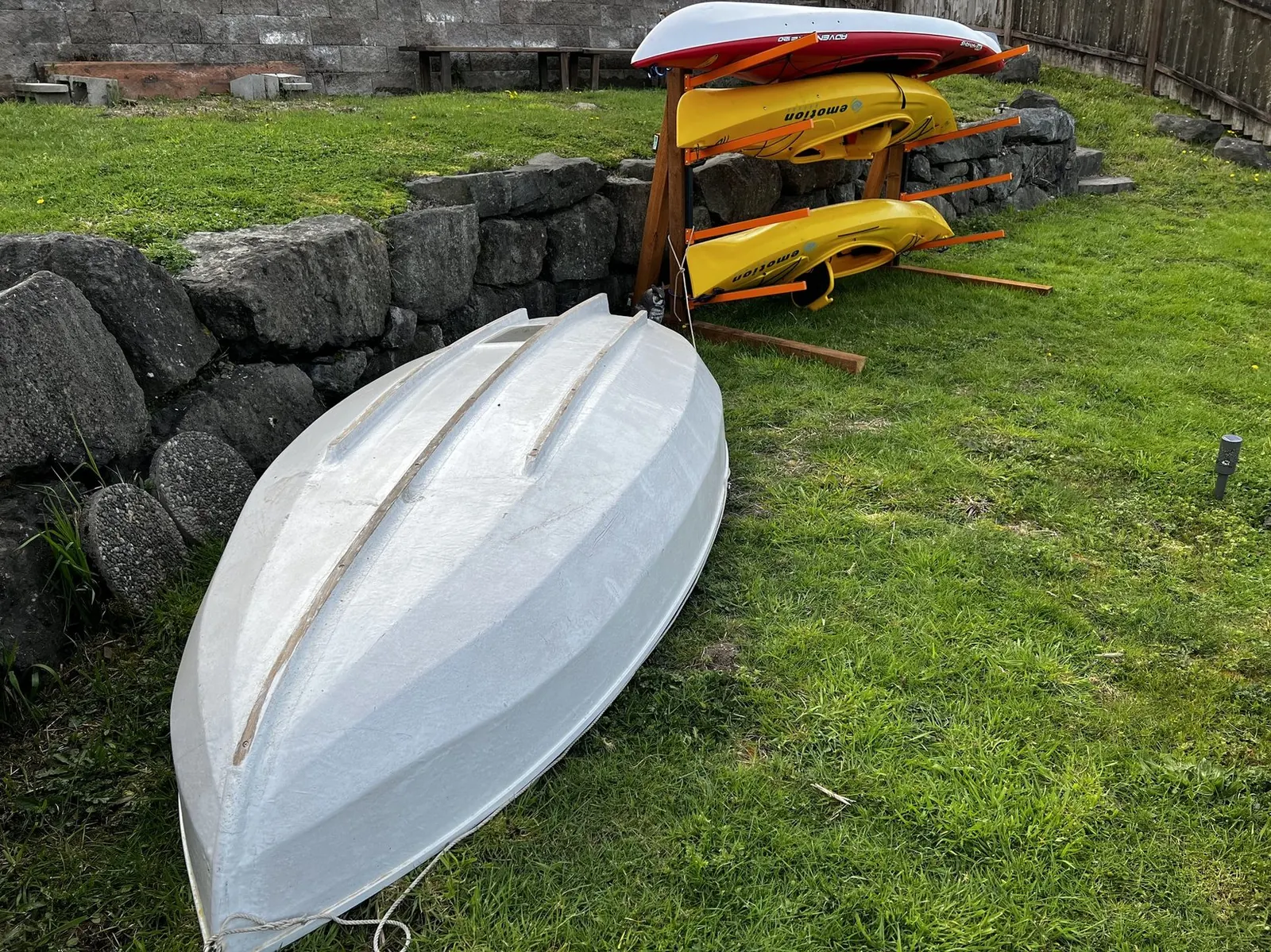 Dinghy boat and kayaks at the dock
